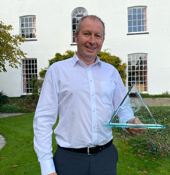 Martyn Openshaw of Spetisbury Construction holding their Building Safety Group Awards trophy