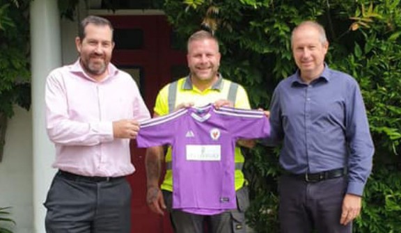 Spetisbury Construction directors Justin Ives and Martyn Openshaw holding a sponsored local football team shirt